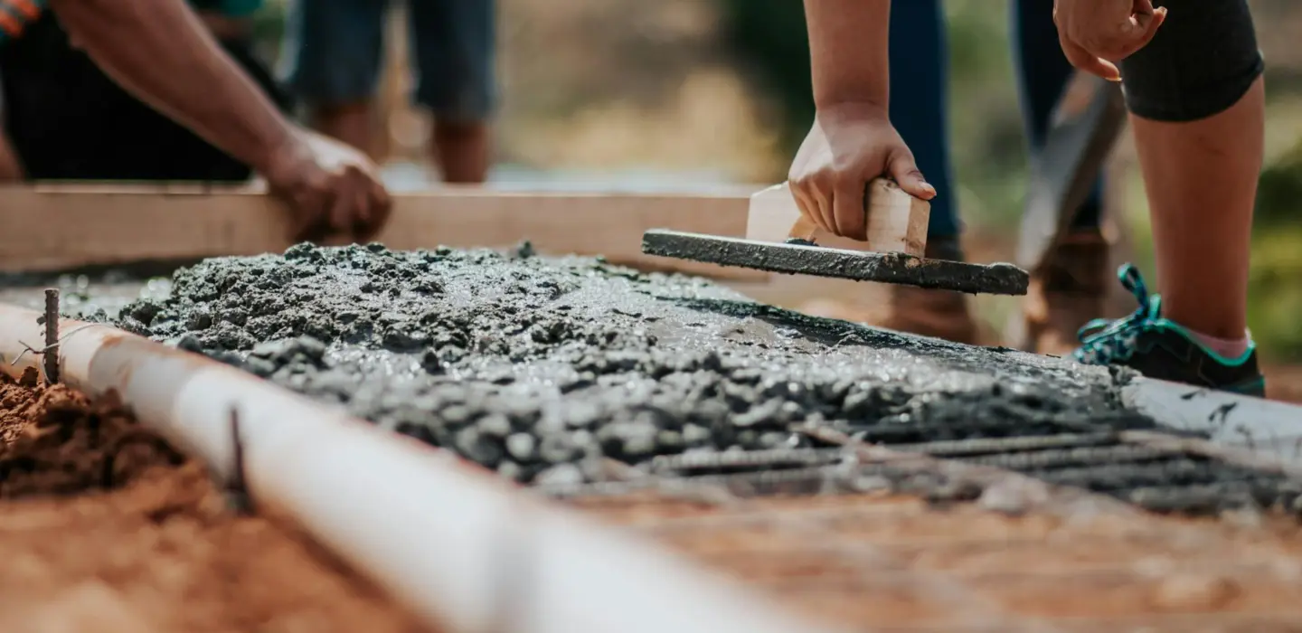 Freshly laid concrete being hand levelled